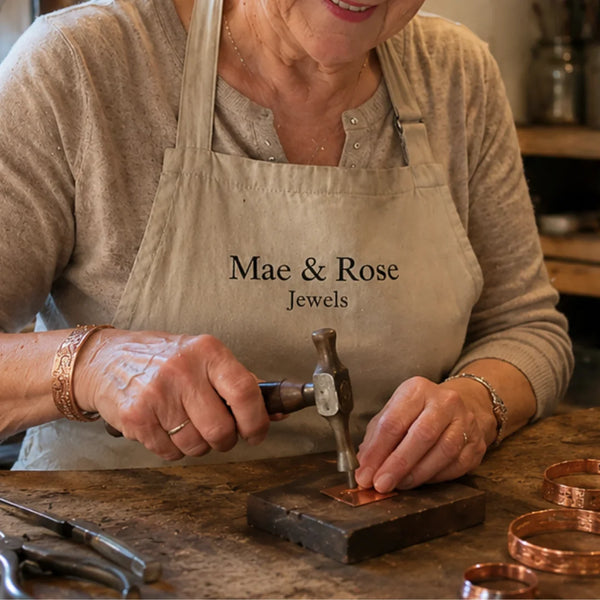 Jeweller hammering copper at a workbench